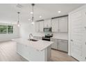 Bright kitchen with pendant lighting, white countertops, and stainless steel appliances at 2352 Citrus Bloom Dr, Bartow, FL 33830