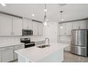 Modern kitchen with stainless steel appliances, white cabinetry, and a spacious center island at 2352 Citrus Bloom Dr, Bartow, FL 33830