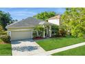 Well-maintained one-story home with an attached two-car garage and manicured lawn at 2412 Stone Cross Cir, Orlando, FL 32828