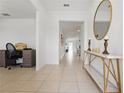 Inviting entryway with a decorative table, a mirror, and tiled flooring leading into a brightly lit home at 3007 Audubon Field Dr, Bartow, FL 33830