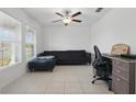 Cozy living room featuring neutral tile floors, modern furniture, and a bright window offering natural light at 3007 Audubon Field Dr, Bartow, FL 33830