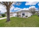 Well-manicured front yard showcasing the home's clean lines, landscaping and curb appeal at 344 China Berry Cir, Davenport, FL 33837