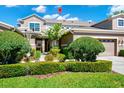 Two-story house with two car garage, well-manicured lawn, and lush landscaping at 585 Cruz Bay Cir, Winter Springs, FL 32708