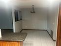 Dining room with tiled floor and modern light fixture, adjacent to the kitchen for convenience at 947 N Atmore Cir, Deltona, FL 32725