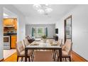 Bright dining room with modern chandelier and seamless flow to the living area at 947 N Atmore Cir, Deltona, FL 32725