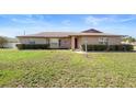 Inviting brick home featuring manicured hedges and a charming front entrance at 947 N Atmore Cir, Deltona, FL 32725