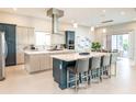 Spacious kitchen featuring a large island with seating, stainless steel appliances, and modern two-tone cabinetry at 960 Jack Nicklaus Ct, Kissimmee, FL 34747