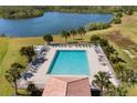 Aerial view of a large community pool surrounded by palm trees and lush landscaping at 1056 Royal Saint George Dr, Orlando, FL 32828