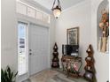 Inviting entryway featuring stylish decor, a tiled floor, and a bright window for natural light at 1056 Royal Saint George Dr, Orlando, FL 32828