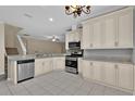 Updated kitchen with stainless steel appliances, granite countertops, and tile flooring at 1056 Royal Saint George Dr, Orlando, FL 32828