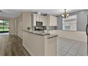Kitchen features granite countertops, stainless steel appliances and modern cabinetry at 1056 Royal Saint George Dr, Orlando, FL 32828