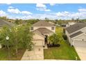 Charming two-story home with attached two car garage and well-manicured lawn and landscaping at 529 Tuten Trl, Orlando, FL 32828
