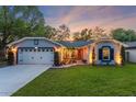 Inviting single-story home showcasing exterior lighting and a well-maintained front yard at 878 W Timberland Trl, Altamonte Springs, FL 32714