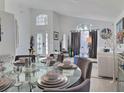 Bright living room with large windows, neutral decor, and views of dining area at 1309 Rebecca Dr, Haines City, FL 33844