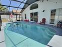Inviting screened-in pool area with ample seating, perfect for outdoor entertaining and relaxation at 1309 Rebecca Dr, Haines City, FL 33844