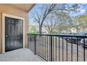 View from private balcony, with dark painted door, and parking lot view at 1321 Arbor Vista Loop # 101, Lake Mary, FL 32746