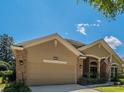 Front exterior of a single Gathering home featuring brick accents, a two car garage, and a well manicured lawn at 1450 Chessington Cir, Lake Mary, FL 32746