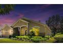 Exterior view of a single Gathering home with a well manicured lawn, garden and a two-car garage at 1450 Chessington Cir, Lake Mary, FL 32746