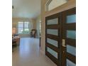 Bright foyer featuring ceramic floors, neutral walls, stylish front door, and view into the comfortable living room at 1450 Chessington Cir, Lake Mary, FL 32746