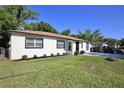 Exterior view of home showing updated exterior, windows and a well-manicured lawn at 1475 Lowrie Ave, Orlando, FL 32805