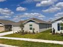Side view of single-story home, highlighting the landscaping and neighborhood setting at 1721 Teagan Ln, Winter Haven, FL 33884