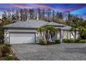 Charming single-story home with a brick driveway and well-manicured landscaping, set against a backdrop of lush trees at 19261 Quarterly Pkwy, Orlando, FL 32833
