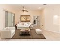 Spacious living room with tile flooring, a white sofa, comfortable armchairs, and a sliding glass door at 19261 Quarterly Pkwy, Orlando, FL 32833
