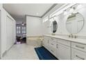 Luxurious bathroom with double vanity, marble floors, soaking tub, and neutral color palette at 2328 Warren Woods Dr, Orlando, FL 32835