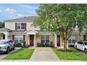 Well maintained townhome showcasing front lawn and red shutters at 2355 Silver Palm Dr, Kissimmee, FL 34747