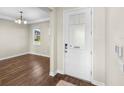 Bright foyer featuring hardwood floors and a decorative front door with patterned glass allowing natural light to filter through at 2383 Regency Park Dr, Deland, FL 32724