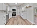 Bright kitchen with white cabinets, stainless steel appliances, and modern finishes at 2417 Healy Dr, Orlando, FL 32818