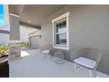 Relaxing front porch area showcasing comfortable wicker chairs and a quaint side table at 2837 Darlington Oak Ln, Ocoee, FL 34761