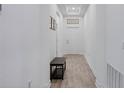 Bright hallway with wood-look tile floors, white walls, and elegant decor at 2837 Darlington Oak Ln, Ocoee, FL 34761