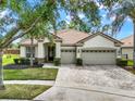 Lovely single-story home features a three-car garage, tile roof, and professionally landscaped front yard at 2843 Maria Isabel Ave, Ocoee, FL 34761