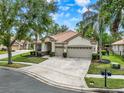 Charming single-story house with a three-car garage, tile roof, and well-maintained landscaping at 2843 Maria Isabel Ave, Ocoee, FL 34761