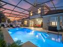 Inviting screened-in pool area with modern outdoor furniture, creating an ideal setting for relaxation and entertainment at 3637 Chandler Estates Dr, Apopka, FL 32712
