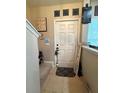 Welcoming foyer with tiled flooring, a white door and a 'welcome' sign at 3664 Wilshire Way Rd # 261, Orlando, FL 32829