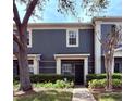 Charming two-story townhome featuring well-maintained landscaping, a welcoming entrance, and mature trees at 3664 Wilshire Way Rd # 261, Orlando, FL 32829