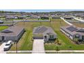 Aerial view of a suburban home in a well-planned community with green lawns at 4718 Magnetite Loop, Mount Dora, FL 32757