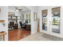 Bright office space featuring hardwood floors, built-in shelving, and a large window at 720 Basin Dr, Kissimmee, FL 34744