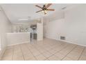 Spacious living room and kitchen combo with tile flooring and abundant natural light at 7435 Groveoak Dr, Orlando, FL 32810
