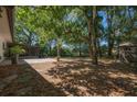 Spacious backyard with mature trees, offering a serene and private outdoor space at 769 Little Wekiva Cir, Altamonte Springs, FL 32714