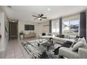 Bright living room with a ceiling fan, neutral tones, and tile flooring, perfect for relaxation at 769 Little Wekiva Cir, Altamonte Springs, FL 32714