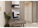 Inviting entryway with stylish bench seating, artwork, and neutral color palette at 977 Paradise Dr, Davenport, FL 33897
