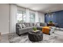 Spacious living room featuring comfortable seating, stylish rug, and plenty of natural light at 977 Paradise Dr, Davenport, FL 33897