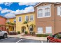 Charming, colorful townhome exterior with lush landscaping and a well-maintained front yard at 979 Park Terrace Cir, Kissimmee, FL 34746