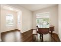 Bright living room featuring gleaming wood floors, large windows, and a piano at 9870 Summerlake Groves St, Winter Garden, FL 34787