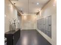 Well-lit mailroom with organized mailboxes and a convenient table with a vase at 101 S Eola Dr # 1209, Orlando, FL 32801