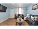 Comfortable living room featuring wood flooring, coastal decor and comfortable grey sofas at 103 Mason Park Dr, Daytona Beach, FL 32117