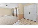 Spacious living room featuring neutral carpeting and large windows for ample natural light at 10900 Tangora St, Orlando, FL 32825